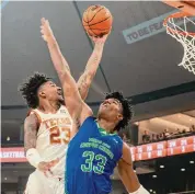  ?? Michael Thomas/Associated Press ?? Texas’ Dillon Mitchell, left, scored 14 points with 13 rebounds for his fifth double-double of the year.