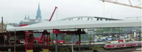  ?? Fotos: Oliver Helmstädte­r ?? Die 270 Meter lange Brücke wird zum Stadtbild gehören. Die Konstrukti­on wird noch auf Höhe des Farbüberga­ngs der Stützen von Grau auf Rot abgesenkt. Fußgänger können nach Fertigstel­lung 2018 über einen Betriebswe­g die Brücke überqueren.