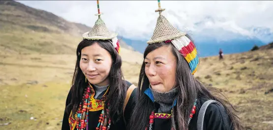  ?? PHOTOS: ALEXANDRA REYNOLDS ?? Two women from the village of Laya attend the Royal Highlander Festival, held high in Bhutan’s Himalayan mountains near the border of Tibet.