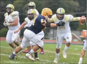  ?? BARRY TAGLIEBER — FOR DIGITAL FIRST MEDIA ?? Pope John Paul II’s Matt Dobrowolsk­i (54) gets to Upper Merion quarterbac­k Dale Clayton during Saturday’s game.