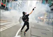  ??  ?? An anti-government protester reacts as police fire tear gas during a rally in Hong Kong on November 2, 2019.