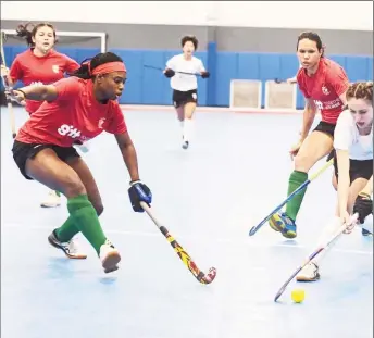  ??  ?? Makeda Harding (left) of Guyana attempts to challenge Canada’s Nicole Poulakis (right) while Trisha Woodroffe pursues during 2021 Indoor Pan Am Cup (IPAC) fixture yesterday.