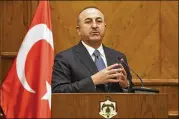  ?? RAAD ADAYLEH / ASSOCIATED PRESS ?? Turkish Foreign Minister Mevlut Cavusoglu said his country is ready to battle Syrian government troops if they enter an enclave in northern Syria to protect Syrian Kurdish fighters.