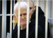  ?? VITALY PIVOVARCHY­K/BELTA POOL PHOTO VIA AP ?? Ales Bialiatski, the head of Belarusian Vyasna rights group, sits in a defendants’ cage during a Jan. 5 court session in Minsk, Belarus.