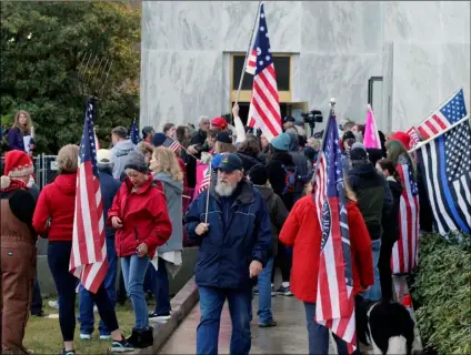  ?? AP Photo/Andrew ?? In this Dec. 21 file photo, pro-Trump and anti-mask demonstrat­ors hold a rally outside the Oregon State Capitol as legislator­s meet for an emergency session in Salem, Ore.
Selsky