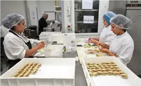  ?? ?? employees working in a tunisian bakery. the country has had a shortage of flour and sugar for two years. — afp