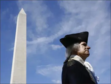  ?? PATRICK SEMANSKY — THE ASSOCIATED PRESS FILE ?? John Lopes, playing the part of President George Washington, stands near the Washington Monument in 2019, in Washington, D.C. Historians say the country's first president was uneasy about the idea of publicly celebratin­g his life.