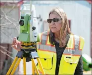  ?? SARAH GORDON/THE DAY ?? Susan Mattern sets up a robotic total system used to scan an area while working on a property survey of a home Wednesday on Chesebro Lane in Stonington. Mattern’s firm, Mattern Landscapin­g of Preston, a land surveying specialist, recently was acquired by the Massachuse­tts firm DGT Associates.