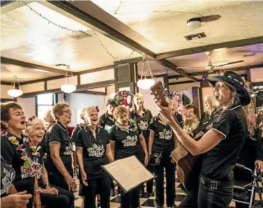  ?? BRADEN FASTIER/STUFF ?? Jo Taylor leads the Off Your Rockers Chorus while they sing Christmas and other songs for the IHC Christmas lunch at the Wakatu Hotel in Nelson.