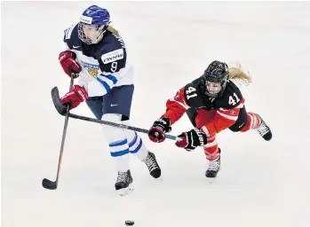  ?? CLAUDIO BRESCIANI/TT/THE ASSOCIATED PRESS ?? Finland’s Jennica Haikaraine­n, left, is checked by Canada’s Kelly Terry during semifinal action Friday in Sweden. Canada won 3-0 to advance to Saturday’s gold medal game against the U.S. It airs at 7 a.m. PST.