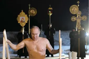  ??  ?? Vladimir Putin emerging from the waters of Lake Seliger during Orthodox Epiphany celebratio­ns, Tver Oblast, Russia, January 2018