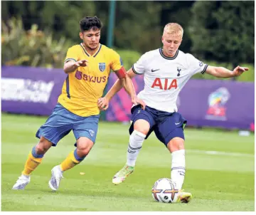  ?? GETTY IMAGES ?? Learning curve:Ayush Adhikari (left) fights for the ball with Billy Heaps of Tottenham Hotspur during the Next Generation Cup in London.