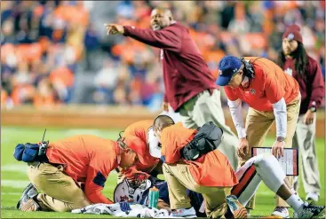  ??  ?? File, Butch Dill / The Associated Press
Gus Malzahn looks on as trainers attend to linebacker Darrell Williams while Alabama A&M head coach James Spady reacts to a targeting call during a 2016 game in Auburn, Ala. College football’s most hated rule...