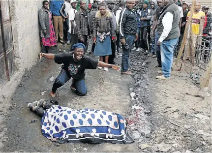  ?? / GORAN TOMASEVIC/REUTERS ?? A woman cries over the body of a supporter of opposition leader Raila Odinga who was killed by police, witnesses said, in Mathare slum in Nairobi, Kenya, on Wednesday.