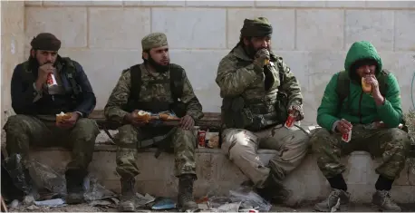  ??  ?? SYRIAN REBEL fighters take a rest during battles around al-Bab in northern Syria.