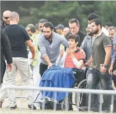  ??  ?? Zaid Mustafa, son and brother of mosque victims Khaled and Hamza Mustafa, leaves after their funeral.