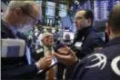  ?? AP PHOTO/RICHARD DREW, FILE ?? Specialist Anthony Matesic, right, works with traders on the floor of the New York Stock Exchange.