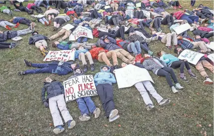  ?? JENNA WATSON/USA TODAY NETWORK ?? Students from the Center for Inquiry School 2 lie down in protest in downtown Indianapol­is.