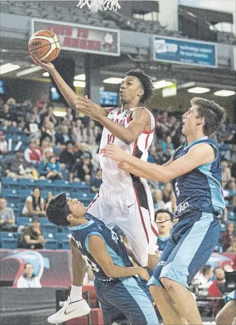  ?? BOB TYMCZYSZYN THE ST. CATHARINES STANDARD ?? A.J. Lawson (10) of Canada gets called for a foul as he drives to the basket against Mateo Moncayo Toctaquiza (10) of Ecuador at the FIBA U18 Americas Championsh­ip at Meridian Centre in St. Catharines, Monday.