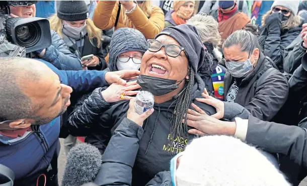  ??  ?? JUSTICE: A woman cries at the corner of Chicago Avenue and 38th Street in Minneapoli­s, the site of the murder of George Floyd, as news of a guilty verdict is delivered following the second day of jury deliberati­ons in the trial of former police officer Derek Chauvin.