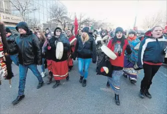  ?? JOHN WOODS THE CANADIAN PRESS ?? Supporters of Thelma Favel, Tina Fontaine’s great-aunt, march past the Manitoba courts in Winnipeg Friday, the day after the jury delivered a not-guilty verdict in the second-degree murder trial of Raymond Cormier.