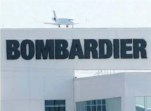  ?? RYAN REMIORZ / THE CANADIAN PRES FILES ?? A plane comes in for a landing at a Bombardier plant in Montreal. Bombardier shares have fallen more than 60 per cent since July on investor unease about its hefty debt and ability to generate promised free cash flow.