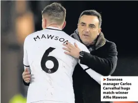  ??  ?? > Swansea manager Carlos Carvalhal hugs match-winner Alfie Mawson