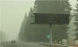  ?? Photograph: Rachel La Corte/AP ?? A fire warning sign is seen through the smoke in Sandy, Oregon, on Monday.