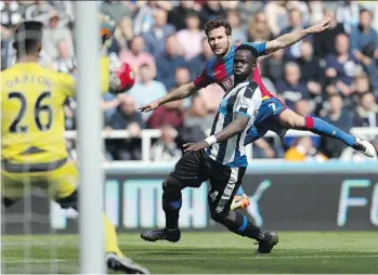  ??  ?? Crystal Palace midfielder Yohan Cabaye fires a shot past Newcastle United midfielder Cheick Tiote during an English Premier League match at St James’ Park in Newcastle-upon-Tyne on April 30.