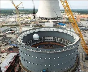  ?? Southern Company ?? This Southern Company photo from July 2017 shows the first of two accumulato­r tanks being placed inside the Unit 3 containmen­t vessel. Part of the passive core cooling system, accumulato­rs are spherical tanks of borated water that, in the event of a loss of reactor coolant, are designed to provide a high rate of coolant flow for several minutes.