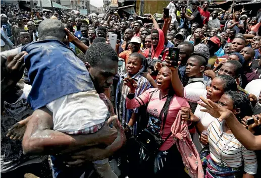  ?? AP ?? A child is rescued from the rubble of a collapsed school in Lagos, Nigeria.