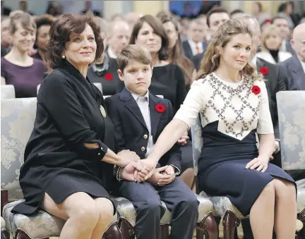  ?? CHRIS WATTIE/AFP/GETTY IMAGES ?? From left, Justin Trudeau’s mother Margaret, son Xavier and wife Sophie Gregoire hold hands before Trudeau is sworn-in as Canada’s 23rd prime minister during a ceremony at Rideau Hall on Wednesday.