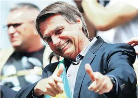  ?? HEULER ANDREY / AFP / GETTY IMAGES ?? Right-wing populist presidenti­al candidate Jair Bolsonaro, a former army captain, has repeatedly praised Brazil’s two-decade-long military dictatorsh­ip and has called a convicted torturer from that time “a Brazilian hero.”