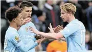  ?? Alex Livesey/Getty Images ?? Dazzling footwork: Oscar Bobb, left, celebrates scoring Manchester City’s winner with teammates Rodri, centre, and Kevin De Bruyne. /