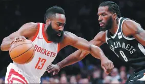  ?? KATHY WILLENS / ASSOCIATED PRESS ?? Houston Rockets guard James Harden takes on Brooklyn Nets forward DeMarre Carroll during Tuesday’s NBA game. The Rockets won 123-113
