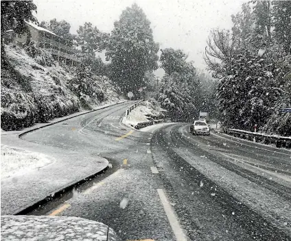  ??  ?? Heavy falls of snow yesterday morning at Arthur’s Point, near Queenstown, delighted many tourists.