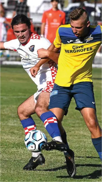  ?? Photo: GCB - John Gass ?? TIGHT BATTLE: Gold Coast Knights player Oskar Dillon (left) battles for possession of the ball with South West Queensland Thunder striker Anthony Grant.