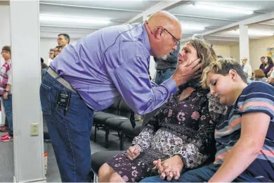  ?? Photos by Lisa Krantz / Staff photograph­er ?? Pastor Frank Pomeroy comforts his wife, Sherri, on what would have been their daughter Annabelle’s 15th birthday.