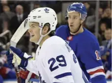  ?? BILL KOSTROUN/THE ASSOCIATED PRESS ?? William Nylander starts the celebratio­n in front of Ranger Kevin Hayes after opening the scoring in Saturday night’s win by the Leafs in New York.