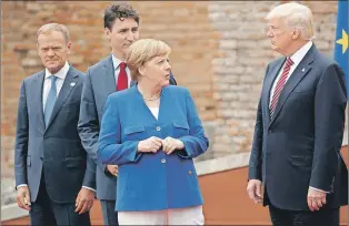  ?? AP PHOTO ?? In this May 26 file photo, German Chancellor Angela Merkel, accompanie­d by European Council President Donald Tusk, Canadian Prime Minister Justin Trudeau, talks with U.S. President Donald Trump during a photo with G7 leaders in Taormina, Italy.