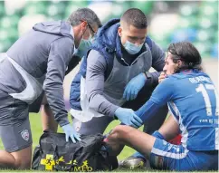  ??  ?? Unlucky break: Coleraine winger Jamie Glackin receives treatment during Monday’s Irish Cup semi-final