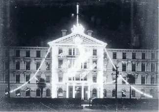  ?? Photo: ALEXANDER TURNBULL LIBRARY 1/2-080523-F ?? Illuminati­ng advance: Electric lights lit up Wellington’s official buildings to celebrate Dominion Day in 1907.