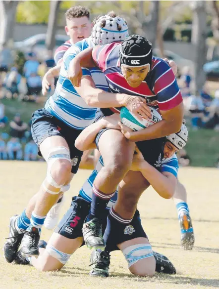  ?? Picture: MIKE BATTERHAM ?? TSS hooker Tyrell Kopua attempts to bust through the Nudgee defence.