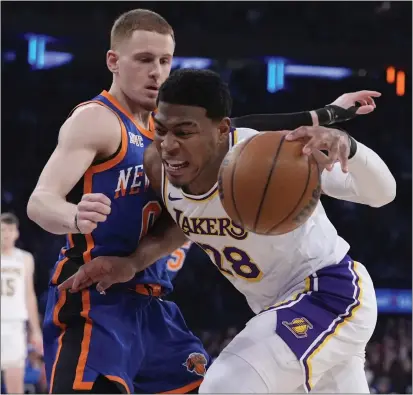  ?? FRANK FRANKLIN II — THE ASSOCIATED PRESS ?? The New York Knicks’ Donte Divincenzo defends the Lakers’ Rui Hachimura during the first half of Saturday’s game in New York.