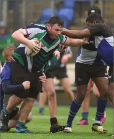  ??  ?? Jack Ryan of Gorey C.S. is tackled by Andrew Cox and Tobi Akinseloyi­an.