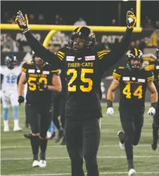  ??  ?? Defensive back Jumal Rolle salutes the fans at Tim Hortons Field. The Ticats are favoured to win the Grey Cup after going 15-3 this season.