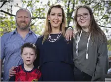  ??  ?? Vicky Phelan arriving for the Public Accounts Committee meeting yesterday, left. Above: With her husband Jim and children Amelia and Daragh. Photos: Steve Humphreys, Fergal Phillips