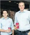  ?? NATHAN DENETTE/THE CANADIAN PRESS ?? Tim Hortons boss Alex Macedo, left, and RBI executive Duncan Fulton pose with the new lids.