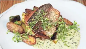  ?? MILWAUKEE JOURNAL SENTINEL ?? Pan-seared whitefish with brussels sprouts, fingerling potatoes and dill pickle remoulade is a main dish at Brandywine restaurant in Cedarburg.