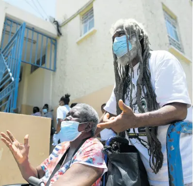  ?? GLADSTONE TAYLOR/MULTIMEDIA PHOTO EDITOR ?? Barrington Facey (right) and common-law wife Veronica Morgan at the Kingston Public Hospital on Thursday. They, like many others, were unable to be treated as a result of a daylong sickout by junior doctors.